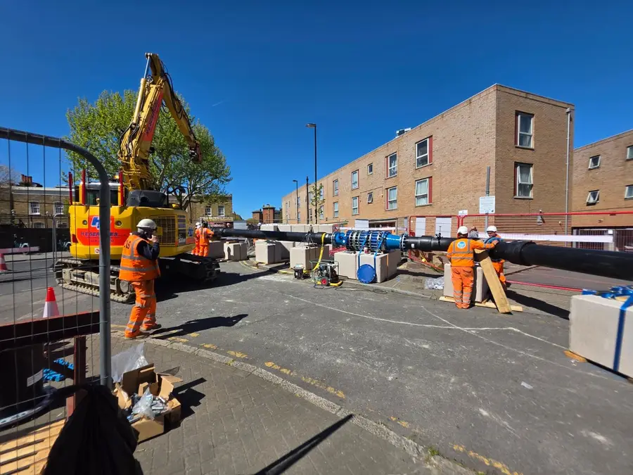 Large-diameter water main being installed on a street by Cascade Water Services
