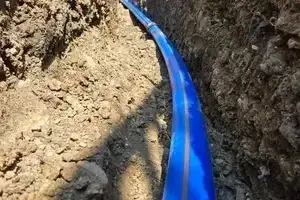 Blue barrier pipe water main laid along the base of the trench