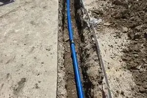 Service pipe run along the building line towards the new unit